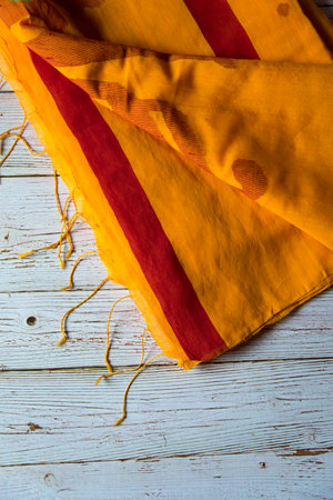 Yellow sari with red border on a background with use of selective focus.の写真素材