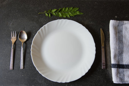 Top view of plate with cutlery on a dark backgroundの写真素材