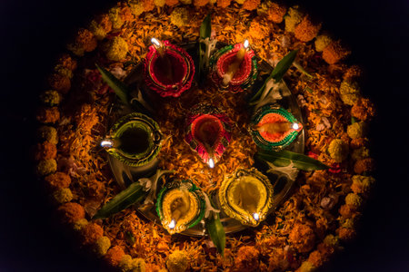 Close up of diya or lamp and flower decorations for the festival of Diwaliの写真素材