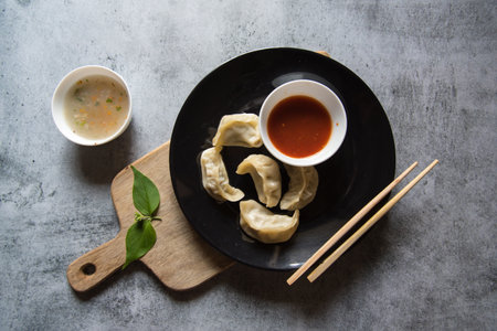Popular snacks dim sum in a plate on a  wooden platter with use of selective focus.の写真素材