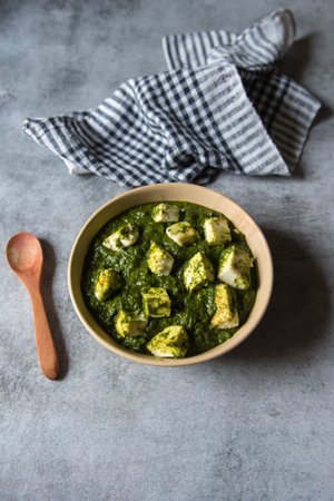 Palak paneer or spinach in cottage cheese curry on a  background. Traditional Indian food. Top view, copy space, selective focus.の素材 [FY310163584363]