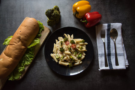 Top view of continental lunch food ingredients pasta and bread with use of selective focusの写真素材