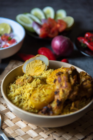 Close up of boiled egg piece on popular food item dum biryani or traditional rice.の写真素材