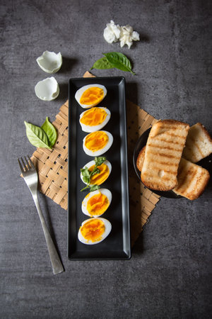 Top view of slices of boiled eggs and bread with use of selective focus on a background.の写真素材