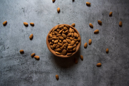 Top view of almonds in a bowl on a background