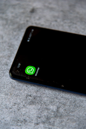 Whatsapp application on smartphone screen on a background.のeditorial素材