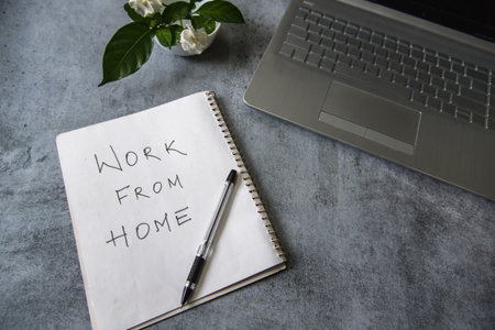 Work from home handwritten with use of selective focus. Work from home is the new normal concept in pandemic times. Close up.の写真素材