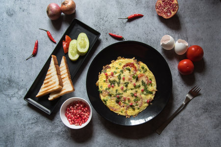 Wholesome breakfast food items frittata served with bread along with condiments. Top view, selective focus.の写真素材