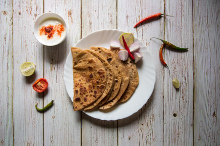 Stuffed sattu ka paratha or channa dal paratha served with condiments and curd. An Indian breakfast dish. Top view.の写真素材