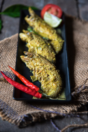 Food background pabda fish in mustard sauce. Close up, selective focus. A delicacy from Eastern...
