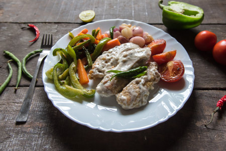 Chicken muniere a continental cuisine prepared with chicken fried in creamy white sauce and served...