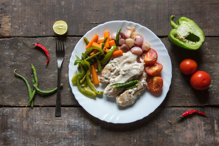Chicken muniere a continental cuisine prepared with chicken fried in creamy white sauce and served...