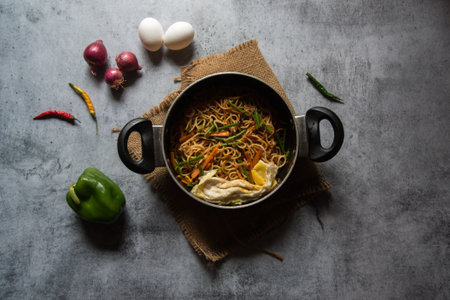 Stir fried noodles prepared with chopped vegetables and udon noodles. View from top.の写真素材