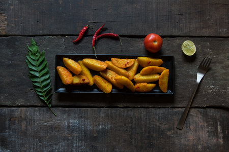 Snacks item baked and crispy potato wedges served with ingredients. Top view.の写真素材
