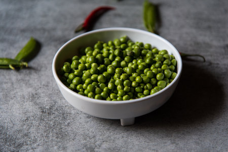 Green peas in a white bowl. Close up, selective focus.の写真素材