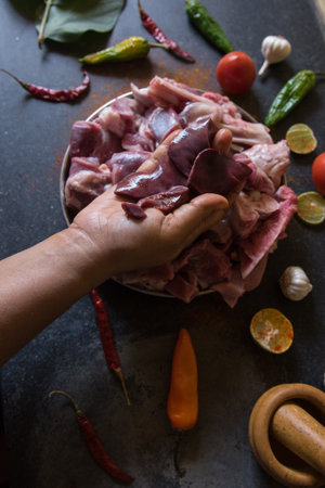 Female hand on raw meat with use of selective focusの写真素材