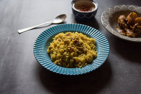 Pulao or basmati rice made with Indian spices and dry fruits served in a blue bowl. Close up,...