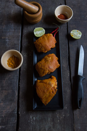 Marinated chicken piece on tray with use of selective focusの写真素材