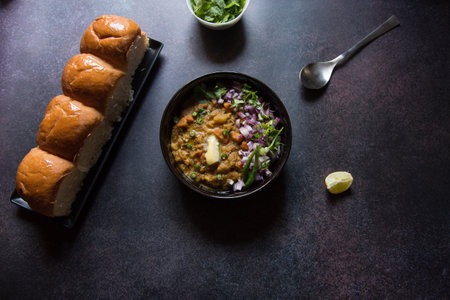 Indian street food pav bhaji served in a bowl. View from top, selective focus.の写真素材