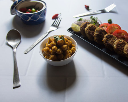 Indian street food chhole or chickpea masala served with tikia. Close up, selective focus.の写真素材