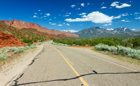 Empty highway winds through the desert canyons of the American Southwest near Moab Utah.の写真素材