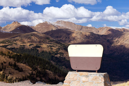 A blank sign for your message in front of a mountain landscape scene on the continential divide in Colorado の写真素材