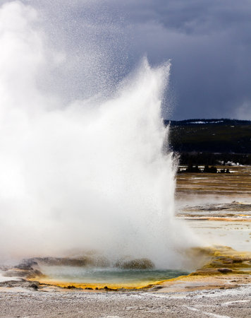 A rainbow colored geyser pool erupts into the air in Yellowstone National Park in Wyoming USA.の写真素材