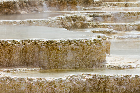Geothermal activity in Yellowstone National Park creates bizzare pools of boiling hot water at the Mammoth Hot Springs in Wyoming.の写真素材