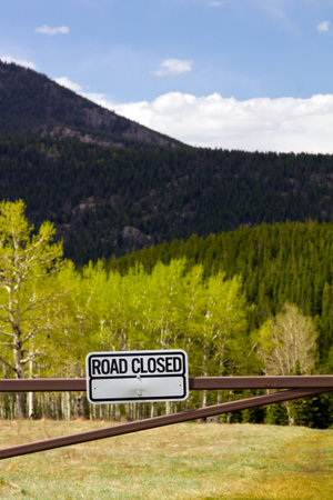 Road closed sign to a dirt road in the outdoorsの写真素材