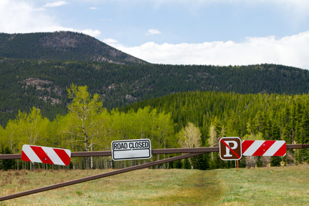 Road closed sign to a dirt road in the outdoorsの写真素材