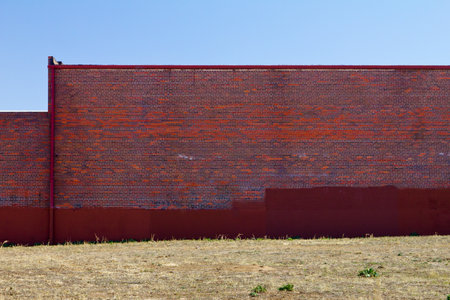 Blank red brick wall of an urban buildingの写真素材
