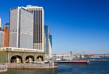 NEW YORK CITY - JANUARY 2013 - Staten Island Ferry docks in lower Manhattan with the Brooklyn Bridge on a clear day in January 2013  As seen from the Staten Island Ferry entering slip のeditorial素材