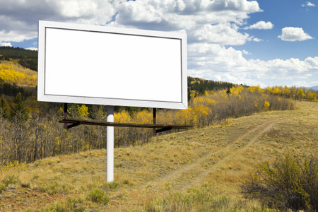 Blank billboard sign on dirt trail through a Fall aspen forest in the Colorado wildernessの写真素材
