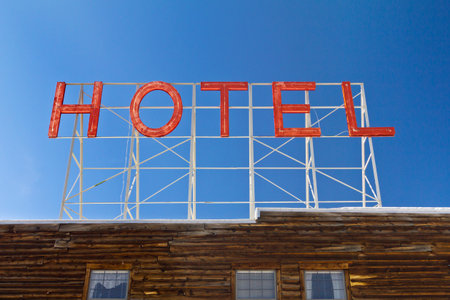 Vintage hotel sign above an old wooden cabin in the Colorado Rocky Mountainsの写真素材