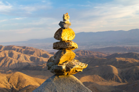 Sunlight shines on pile of rocks stacked in desert landscapeの写真素材