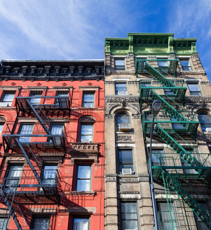 Colorful old vintage apartment buildings with fire escapes in the Greenwich Village neighborhood of...
