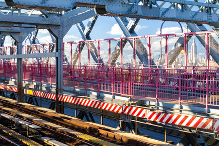 Scenic view of the Williamsburg Bridge subway tracks and pedestrian walkway with Manhattan skyline...