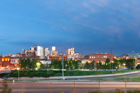 Sunset light reflects off the buildings of downtown Denver, Coloradoの写真素材