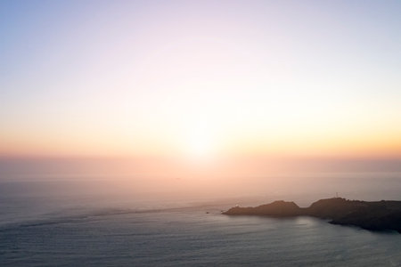 Glowing light of sunset shines across the horizon of the Pacific Ocean off the coast of California...