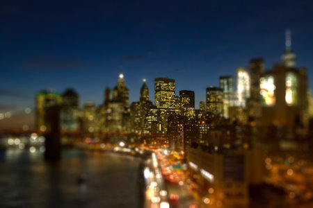 New York City skyline lights at night with the colorful lights of the downtown skyscrapers with...