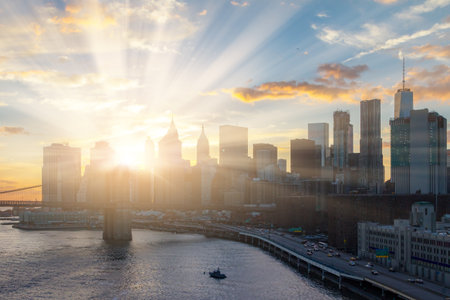 Sunlight shines behind New York City skylineの写真素材