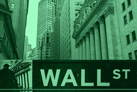 Wall Street sign and New York Stock Exchange buildings in money green colorの写真素材