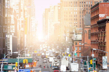 Sunlight shines down the busy streets of Chelsea in Manhattan, New York City NYCの写真素材