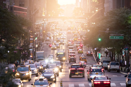 Crosstown traffic on 42nd Street in Midtown Manhattan New York City with sunlight in backgroundの写真素材
