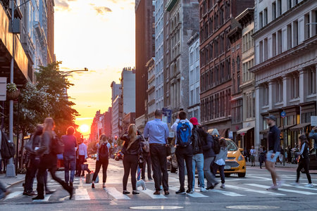 NEW YORK CITY, CIRCA 2018: Crowds of people gather in an intersection on 23rd Street to take photos of the evening sunset in Manhattan, New York City a few days after Manhattanhengeのeditorial素材