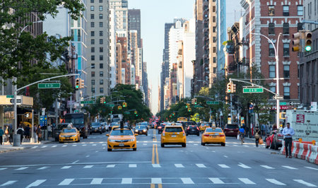 NEW YORK CITY - CIRCA 2018: Yellow taxis drive down 3rd Avenue in the East Village neighborhood of...