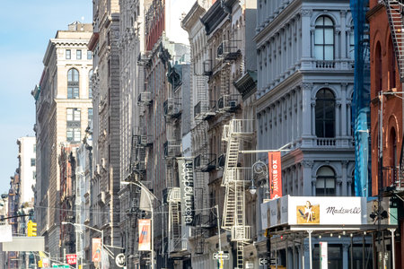 NEW YORK CITY, CIRCA 2018: Signs and banners for the businesses along Broadway hang from the historic buildings in the SoHo neighborhood of Manhattan in NYC.のeditorial素材