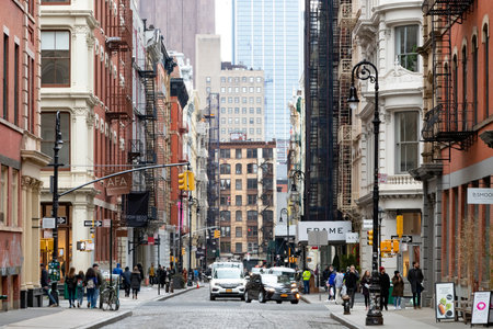 NEW YORK CITY - CIRCA 2019: Busy intersection of Broome and Greene Streets is crowded with people and cars in the SoHo neighborhood of Manhattan in NYC.のeditorial素材
