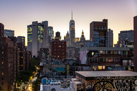 NEW YORK CITY, CIRCA 2019: The colorful lights of the NYC skyline shine as evening falls on the buildings and streets of Manhattan.のeditorial素材