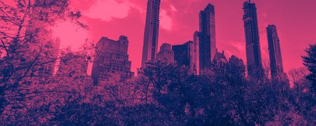 New York City skyline with the buildings of Manhattan framed by trees of Central Park with pink and blue duotone color effectの写真素材